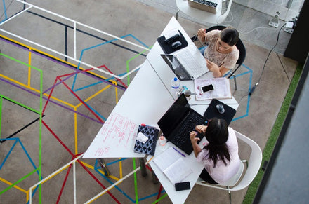 Two female workers at office with good communication
